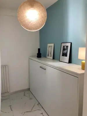 a room with a white refrigerator and a light at Studio contemporain à Cannes avec terrasse et parking - 35 m² in Cannes