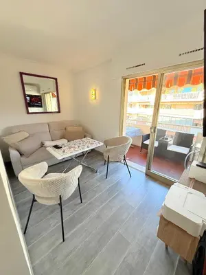 a living room with a couch and a table and chairs at Le Gallieni in Cannes