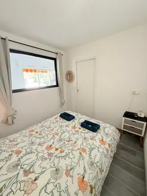 a bedroom with a bed with a floral bedspread at Le Gallieni in Cannes