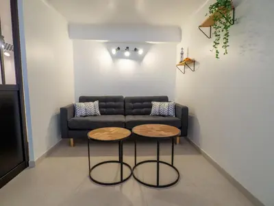 a living room with a couch and two tables at Appartement centre de Cannes in Cannes