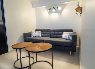a living room with a couch and two tables at Appartement centre de Cannes in Cannes