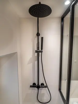 a black lamp in a bathroom with a mirror at Appartement centre de Cannes in Cannes