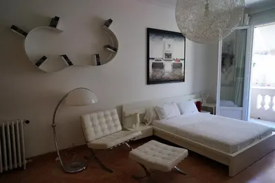 a bedroom with a bed and a lamp and a chair at 124 MIRAMAR 65 LA CROISETTE in Cannes