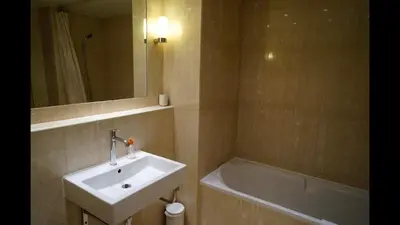 a bathroom with a sink and a bath tub at 124 MIRAMAR 65 LA CROISETTE in Cannes