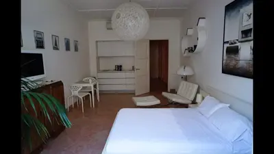 a bedroom with a white bed and a kitchen at 124 MIRAMAR 65 LA CROISETTE in Cannes