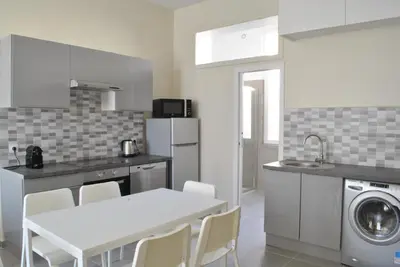 a kitchen with a white table and a sink and a washing machine at Lecerf 2P ZEI5517 in Cannes