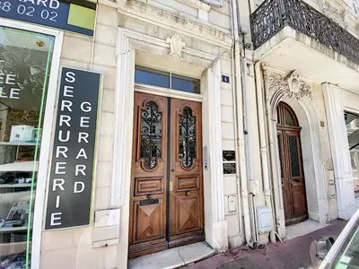 a building with a large wooden door on a street at Lecerf 2P ZEI5517 in Cannes