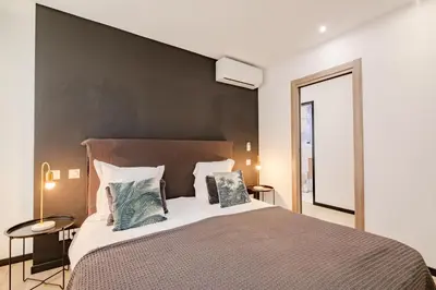 a bedroom with a large bed with two pillows at Scandinavian Urban 1 - 2BR apartment in center close to Palais des Festivals and the beach in Cannes
