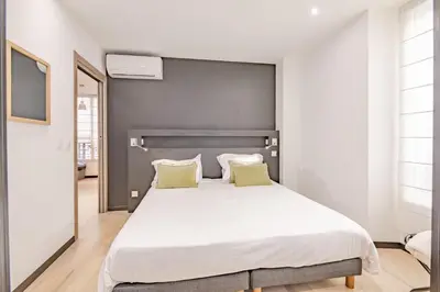 a bedroom with a large white bed with two pillows at Scandinavian Urban 1 - 2BR apartment in center close to Palais des Festivals and the beach in Cannes