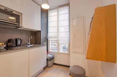 a kitchen with white cabinets and a window at Scandinavian Urban 1 - 2BR apartment in center close to Palais des Festivals and the beach in Cannes