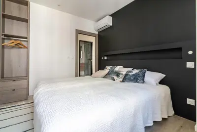 a black and white bedroom with a large bed at Scandinavian Urban 2 - 2BR apartment in center close to Palais des Festivals and the beach in Cannes