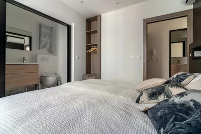 a bedroom with a large bed and a bathroom at Scandinavian Urban 2 - 2BR apartment in center close to Palais des Festivals and the beach in Cannes