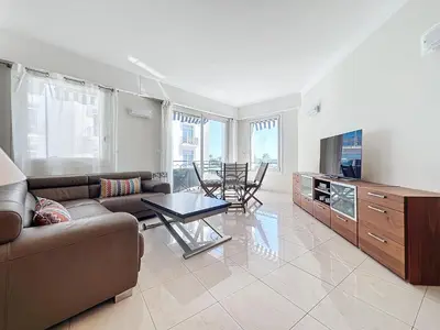 a living room with a couch and a table at Luxury 1 bedroom Croisette Martinez direct sea view 241 in Cannes