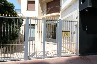 a white gate in front of a building at Luxury 1 bedroom Croisette Martinez direct sea view 241 in Cannes