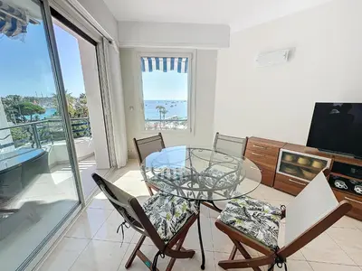 a dining room with a glass table and chairs at Luxury 1 bedroom Croisette Martinez direct sea view 241 in Cannes
