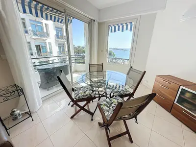 a dining room with a glass table and two chairs at Luxury 1 bedroom Croisette Martinez direct sea view 241 in Cannes