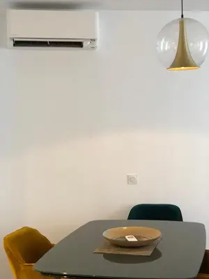 a table with two chairs and a plate on it at Luxe et Confort - Proche Palais et plages - A/C in Cannes