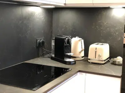 a kitchen with a toaster and a coffee maker on a counter at Luxe et Confort - Proche Palais et plages - A/C in Cannes