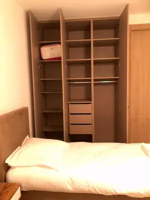 a bedroom with a bed and a book shelf at Luxe et Confort - Proche Palais et plages - A/C in Cannes