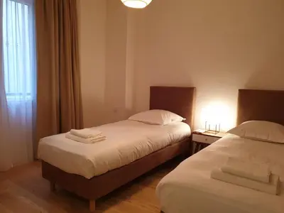a hotel room with two beds and a window at Luxe et Confort - Proche Palais et plages - A/C in Cannes