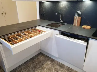 a kitchen with white cabinets and a sink at Luxe et Confort - Proche Palais et plages - A/C in Cannes