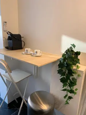 a wooden table with two cups and a plant at STUDIO 45 CROISETTE CANNES in Cannes