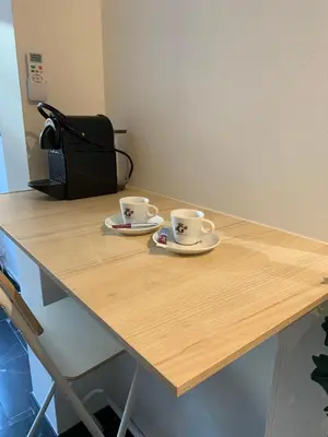 two coffee cups sitting on a wooden table at STUDIO 45 CROISETTE CANNES in Cannes