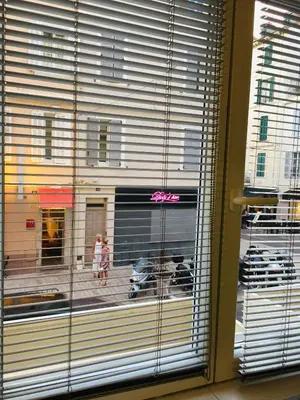 a window with a view of a street and a motorcycle at STUDIO 45 CROISETTE CANNES in Cannes