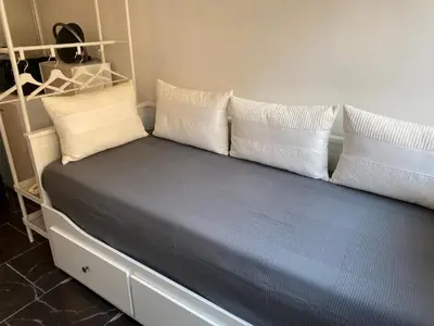 a bed with white pillows and a blue mattress at STUDIO 45 CROISETTE CANNES in Cannes