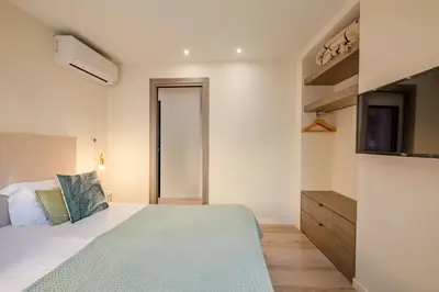 a bedroom with a bed and a television in it at Scandinavian Urban 3 - 2BR apartment in Cannes center - close to the beach and Palais in Cannes