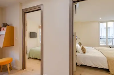 a bedroom with a bed and a mirror at Scandinavian Urban 3 - 2BR apartment in Cannes center - close to the beach and Palais in Cannes