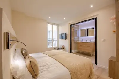 a bedroom with a bed and a bathroom with a sink at Scandinavian Urban 3 - 2BR apartment in Cannes center - close to the beach and Palais in Cannes