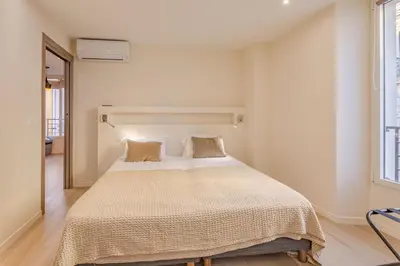a bedroom with a large white bed with two pillows at Scandinavian Urban 3 - 2BR apartment in Cannes center - close to the beach and Palais in Cannes