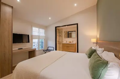a bedroom with a large bed with a television at Scandinavian Urban 4 - 1BR apartment in Cannes center close to the beach and the Palais in Cannes
