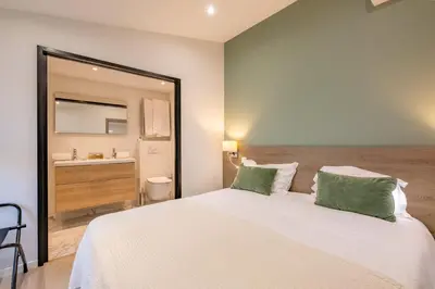 a bedroom with a large white bed with a sink at Scandinavian Urban 4 - 1BR apartment in Cannes center close to the beach and the Palais in Cannes