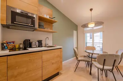a kitchen with a table and a dining room at Scandinavian Urban 4 - 1BR apartment in Cannes center close to the beach and the Palais in Cannes