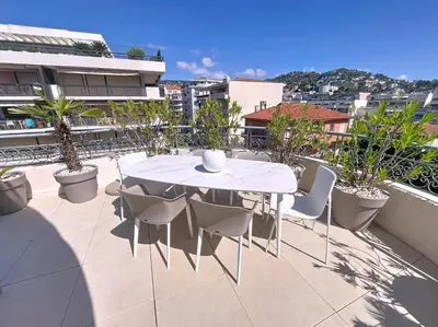 a white table and chairs on a balcony at Fantastic penthouse 3 bedroom Croisette 406 in Cannes