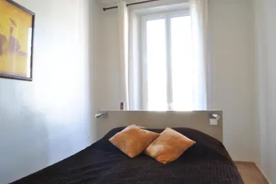a bedroom with a bed with two pillows on it at Lecerf 2P CUR1095 in Cannes