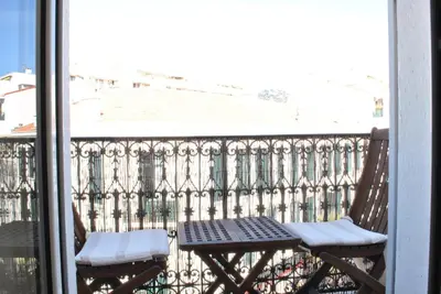 a balcony with a table and chairs on a balcony at Lecerf 2P CUR1095 in Cannes