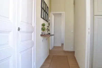 a hallway with white walls and a door with a rug at Lecerf 2P CUR1095 in Cannes