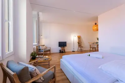 a bedroom with a bed and a living room at Marechal Foch / GOLD2025 / ST in Cannes