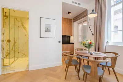 a kitchen and dining room with a table and chairs at La Guitare 21 - Cozy studio in center of Cannes, just behind Grand Hotel in Cannes