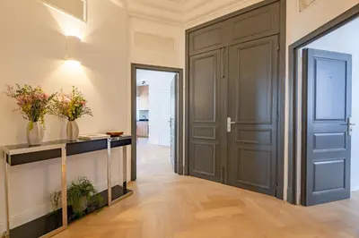 a hallway with a door and a table with flowers at La Guitare 21 - Cozy studio in center of Cannes, just behind Grand Hotel in Cannes
