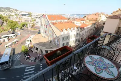 a balcony with a view of a street and buildings at 1 bedroom Suquet, 6 min from the Palais, balcony city & port view 220 in Cannes