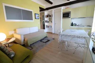 a room with a bed and a table and a kitchen at 1 bedroom Suquet, 6 min from the Palais, balcony city & port view 220 in Cannes