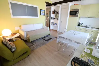 a living room with a couch and a table at 1 bedroom Suquet, 6 min from the Palais, balcony city & port view 220 in Cannes