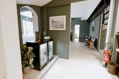 a living room with green walls and a tv at Ideal Sejour Cannes - Hôtel de Charme in Cannes