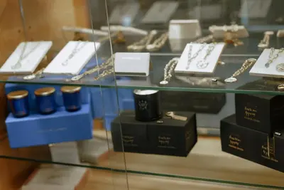 a display case with a bunch of watches and other items at Ideal Sejour Cannes - Hôtel de Charme in Cannes