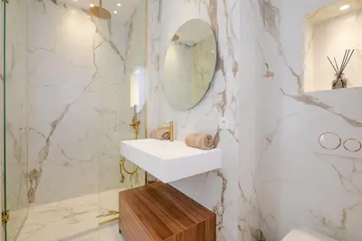 a bathroom with a sink and a mirror at La Guitare 22 - Spacious 1 BR apartment in the center of Cannes, right behind Grand Hotel in Cannes