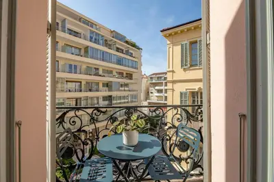 a balcony with a table and a cup on it at La Guitare 23 - Large modern studio with balcony in center of Cannes, just behind Grand Hotel in Cannes